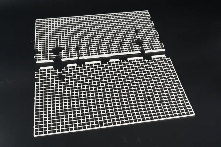 Clear Ribbed Component Clear injection molded grid component with fine ribs