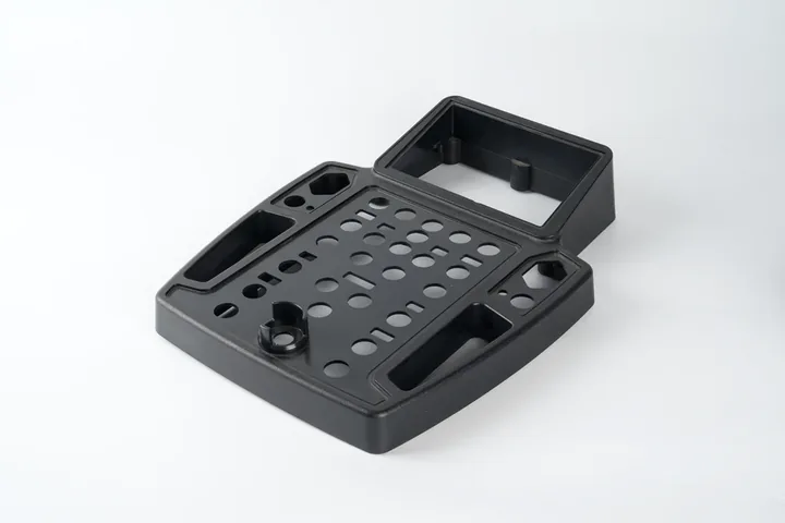 Black injection molded technical mounting component