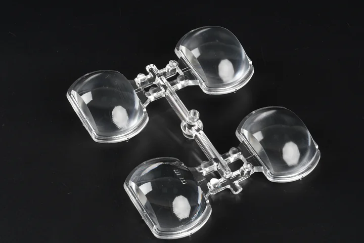 Transparent injection molded four-lens optical array