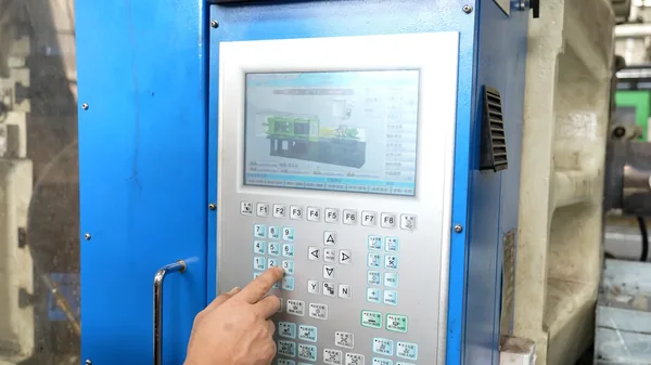Injection Molding Process Control Operator setting injection molding process parameters at the machine control